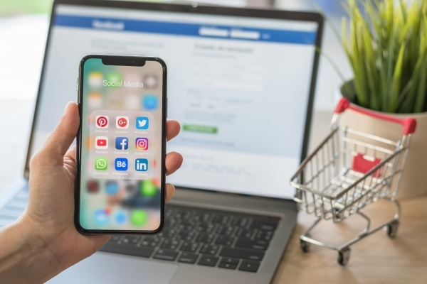 Social media app multi-channel icons on iphone X touchscreen mobile computer cross-channel internet application technology for shopping lifestyle in digital 4.0 age