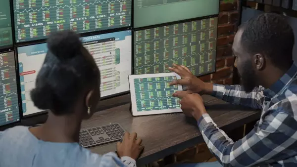 african-american-man-and-woman-monitoring-exchange-2022-03-15-18-17-45-utc