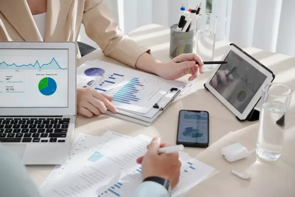 colleagues-comparing-sales-reports-2021-11-11-03-27-08-utc