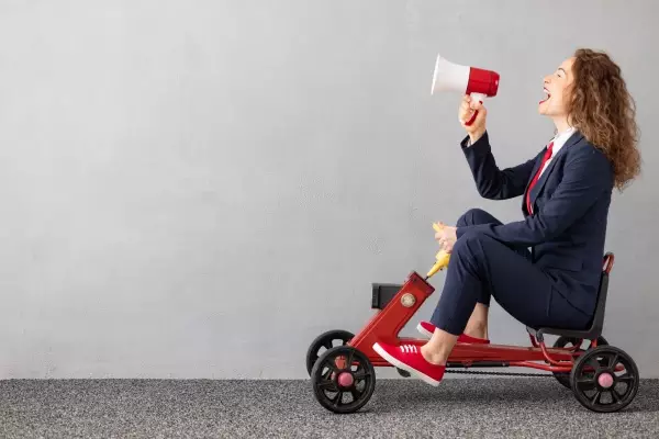 successfull-businesswoman-driving-toy-car-outdoor-2021-09-01-06-33-53-utc